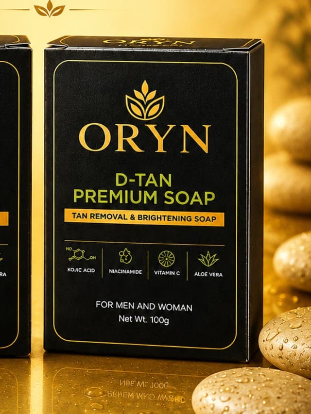 ORYN Aqua Soap and D-TAN Premium Soap cartons on wet gold stone
