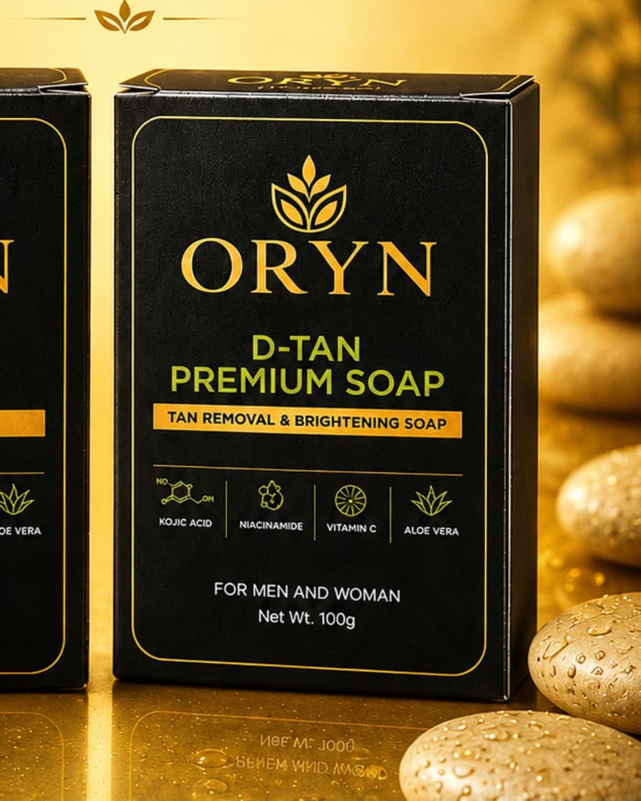 ORYN Aqua Soap and D-TAN Premium Soap cartons on wet gold stone